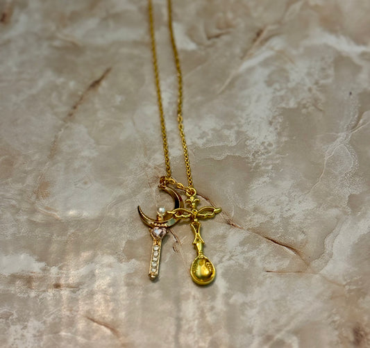 Gold-plated chain necklace with a miniature spoon charm and accent pendant on an adjustable lobster-clasp chain
