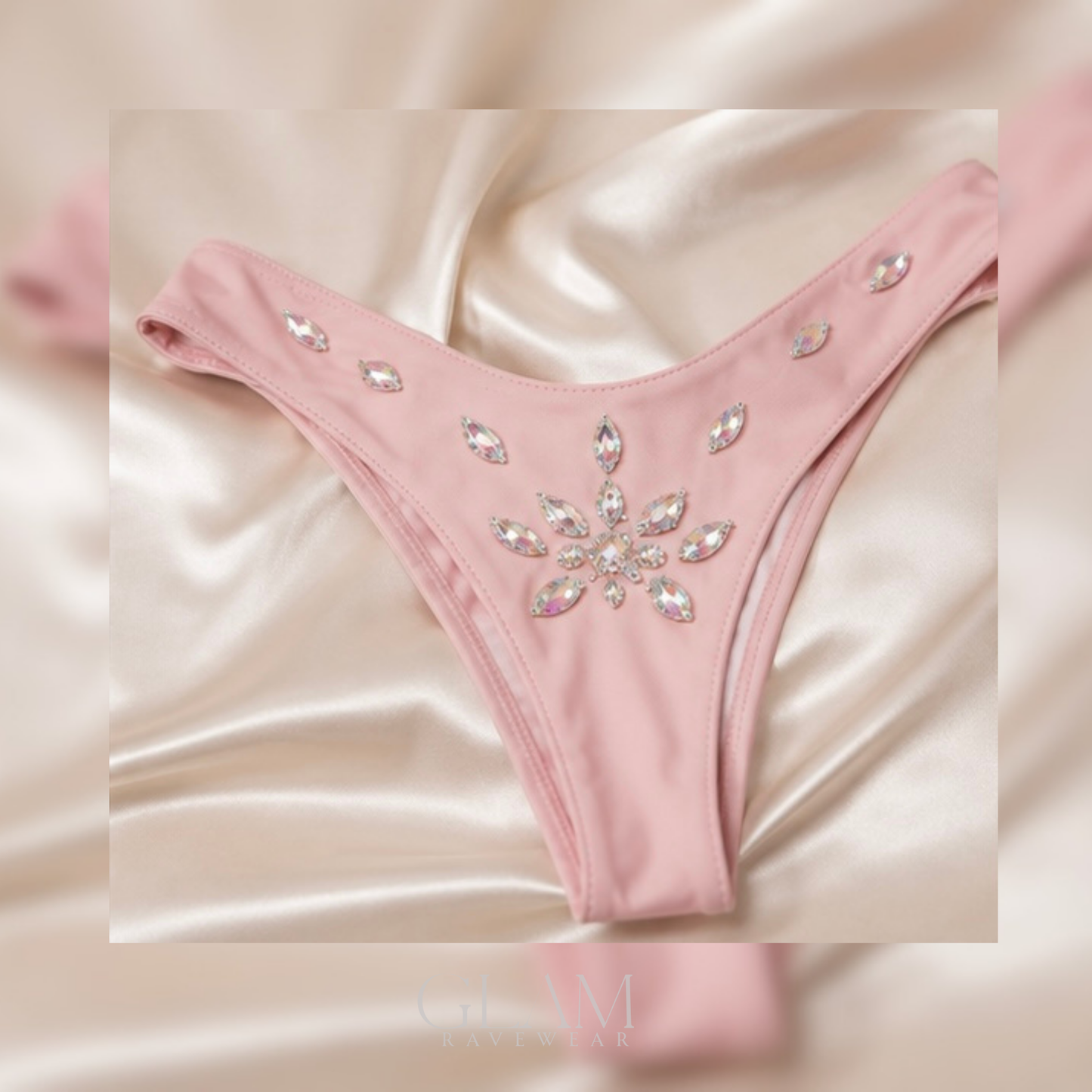 Baby pink Diamond Dreams rhinestone festival bikini bottoms shown in a flat lay with crystal details, soft glam styling, and luxury ravewear aesthetic.